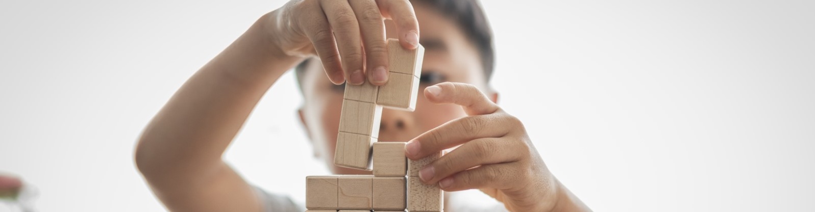 child building jenga blocks desktop.jpg