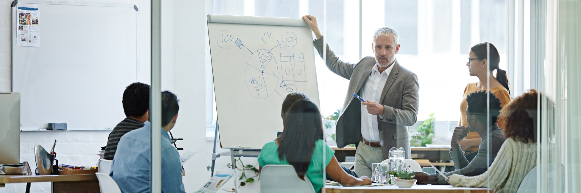 man presenting in a meeting room flip chart_header.jpg