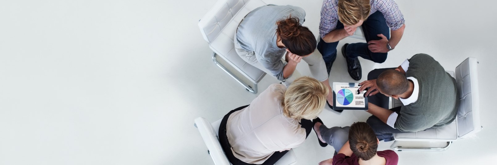 five people talking over a tablet Cropped.jpg