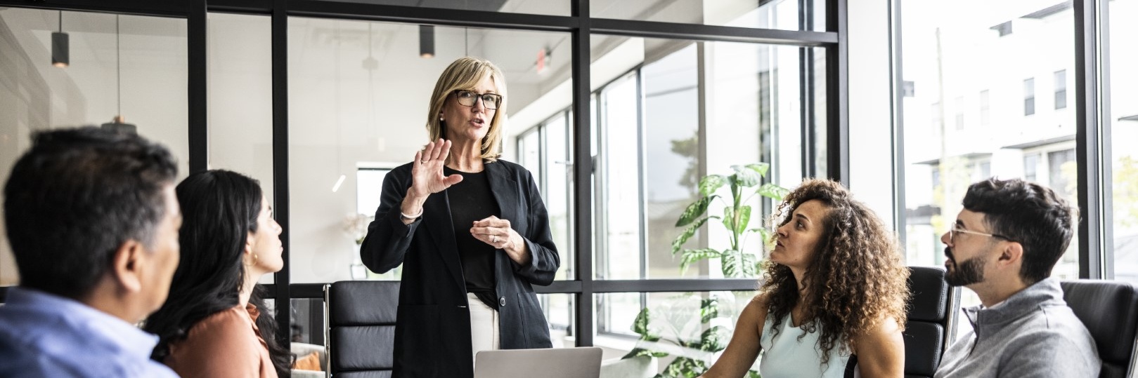 woman talking at a meeting in the office Cropped.jpg