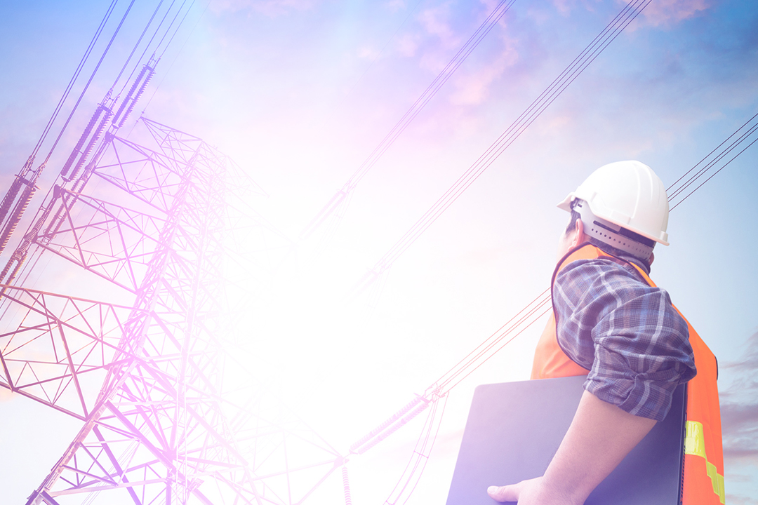 Electrical engineer looking at electricity pole